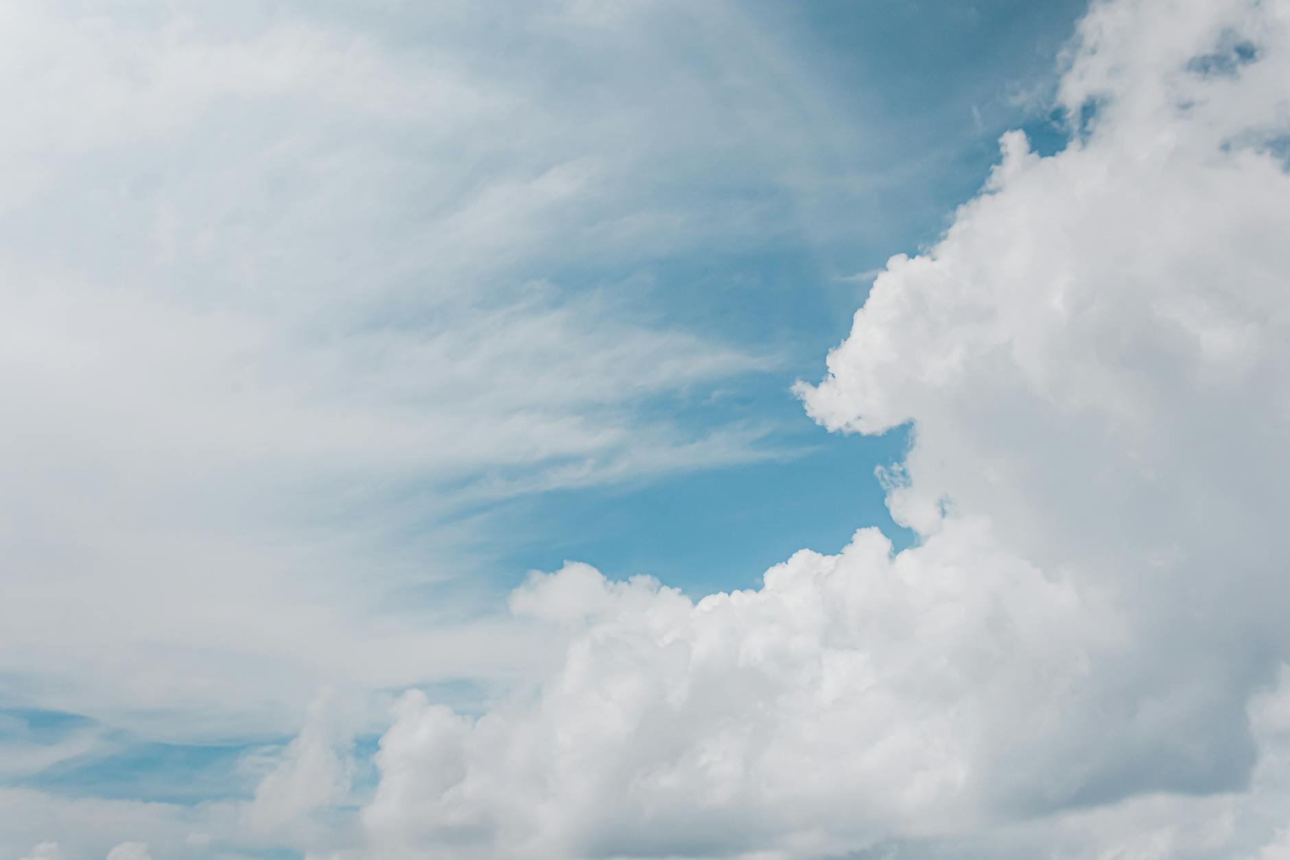 serene blue sky with white fluffy clouds